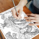 A person's hands holding colored pencils, carefully coloring a detailed western-themed coloring page. The page features a cowboy on horseback riding beside a long-horn cow, set against a rustic, open landscape.